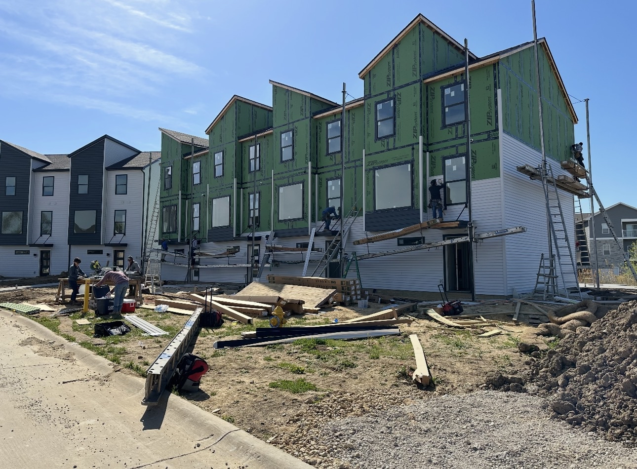 Townhomes mid-construction with exposed sheathing